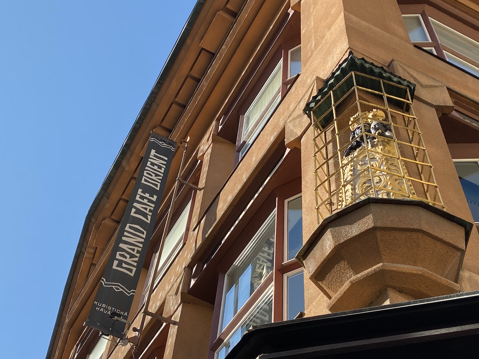 Black Madonna and sign for Grand Orient Cafe Prague