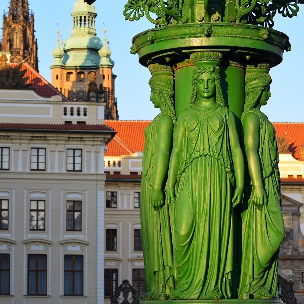 Green lamppost with women figures near Prague Castle
