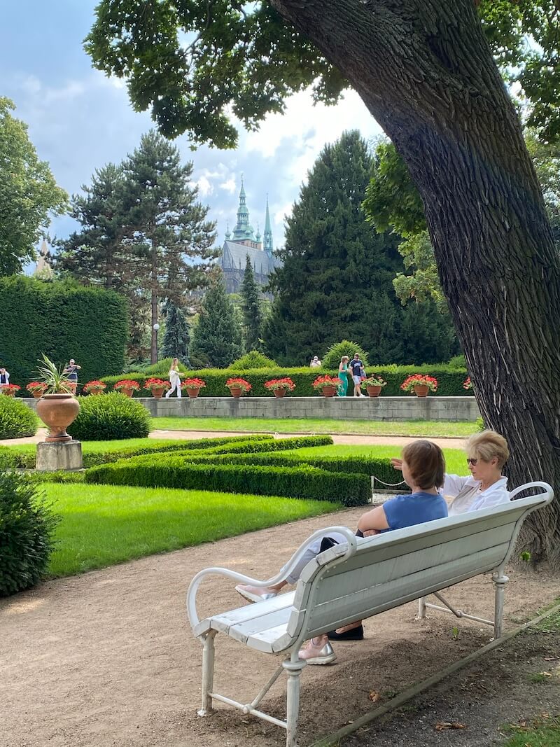 People sitting on a bench in the garden of Queen Anne Summer Palace People sitting on a bench in the garden of Queen Anne Summer Palace