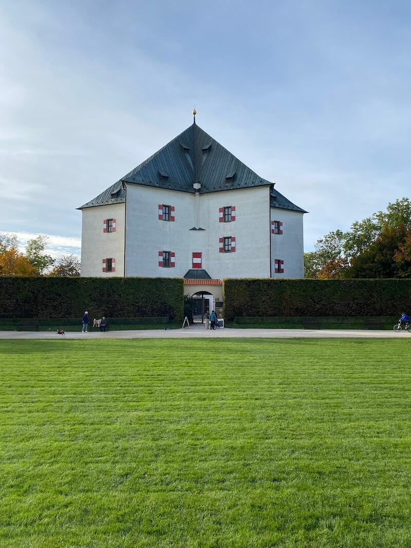 Vertical shot of front of star palace with green field in front