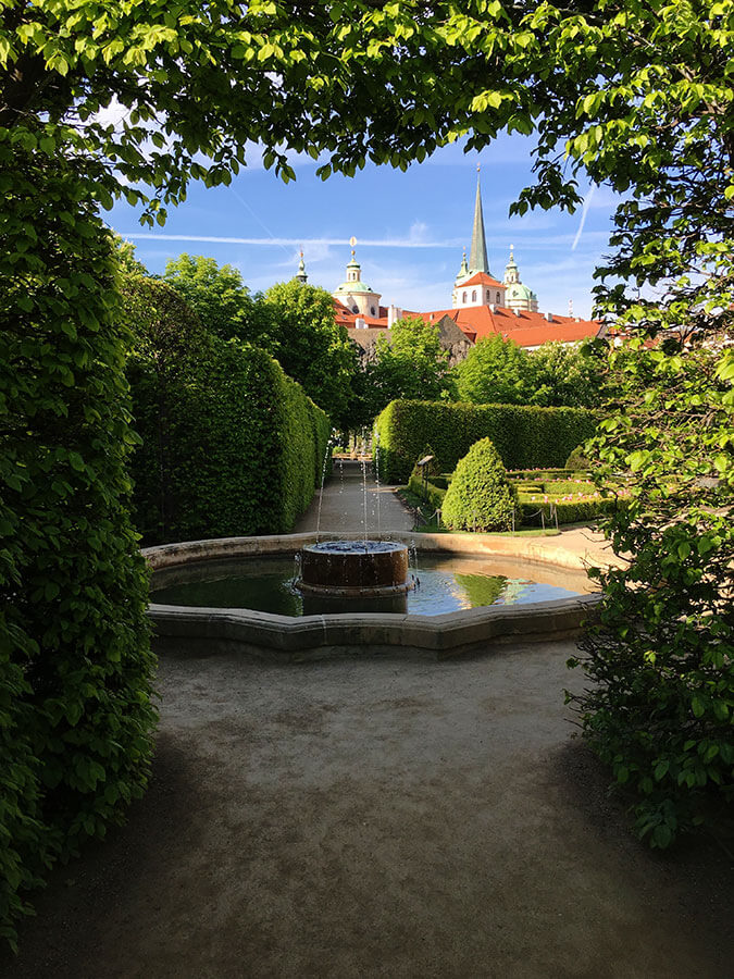 Wallenstein garden through bushes with fountain verical 600x900